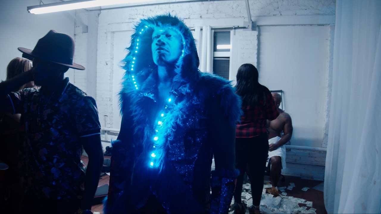 a man in a fur trimmed hood adorned with lights